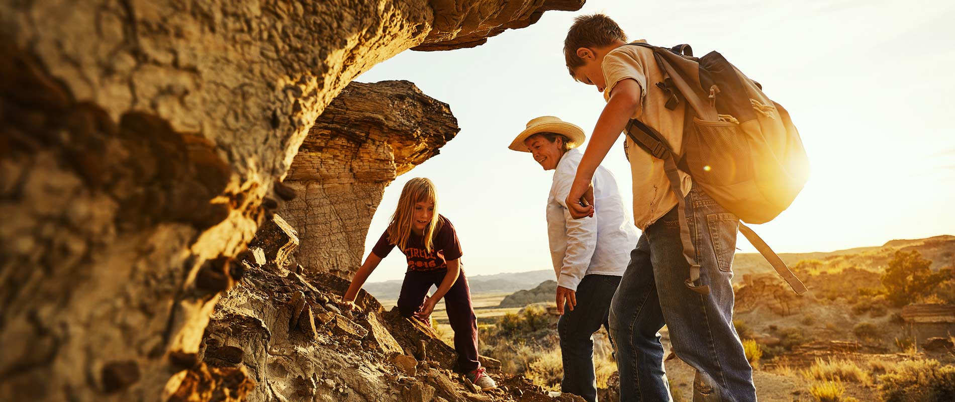 Two kids and adult on rock Baischs Dinosaur Dig